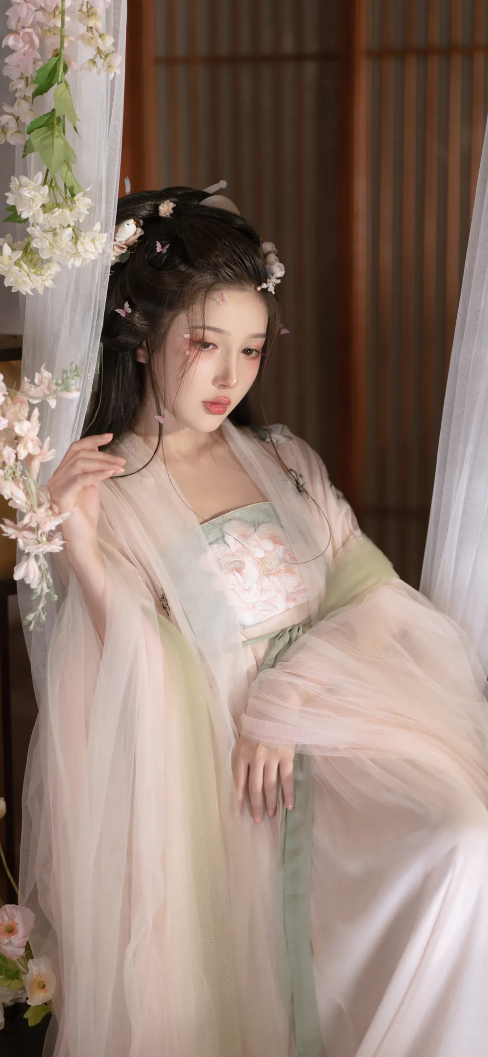 Serene Asian Girl in Traditional Hanfu with Floral Wallpaper